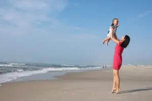 Mom playing with her baby at beach
