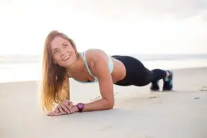 woman exercising on the beach