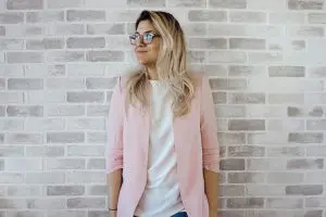 professional woman in pink blazer