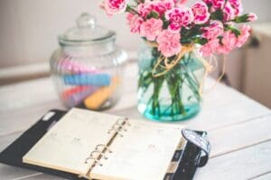 planner and flowers on desk