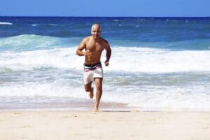 Campanile - Healthy man running on the beach